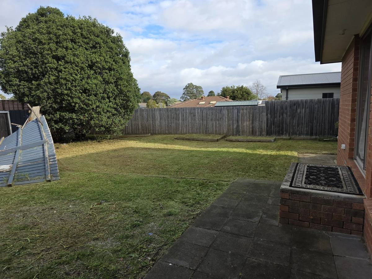 The same Frankston backyard after the clean-up, mown flat with the paving cleared and the waste gone